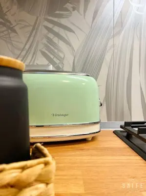a toaster sitting on top of a wooden table at Roma Suite Epiro in Rome