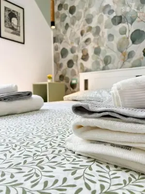 a room with a pile of towels on a bed at Roma Suite Epiro in Rome