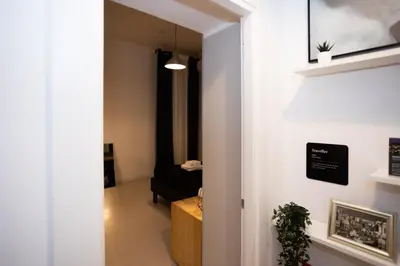 a hallway with a door leading to a living room at Persia Collection Colosseo in Rome