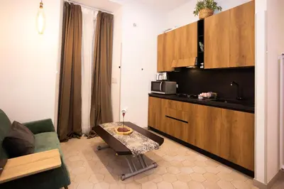 a kitchen with a couch and a table in a room at Persia Collection Colosseo in Rome