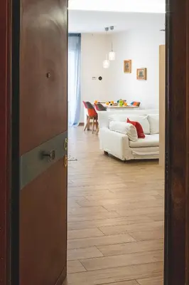 a door leading into a living room with a couch at Cozy flat with terrace at Trastevere train station in Rome