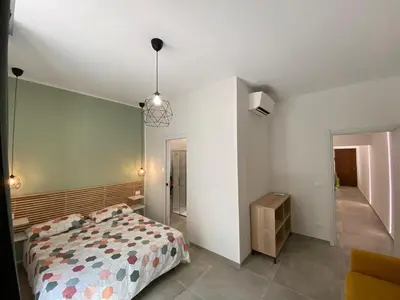 a bedroom with a bed and a room with a hallway at Laura Apartment in Rome