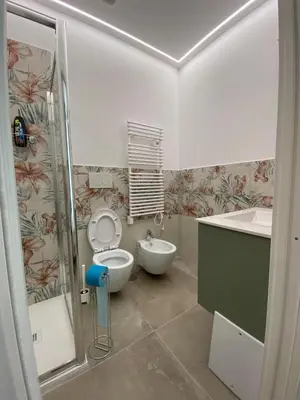 a bathroom with a toilet and a sink at Laura Apartment in Rome