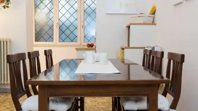 a dining room table with chairs and a window at Atheneum by Rental in Rome in Rome