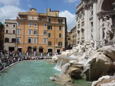 a fountain in a city with people standing around it at Rental in Rome Celeste Apartment in Rome