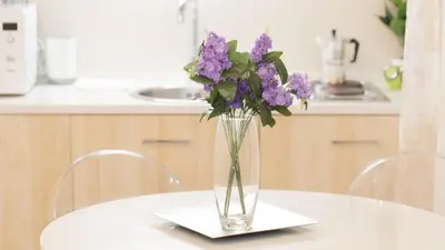 a vase of purple flowers sitting on a table at Consulta By Rental In Rome in Rome