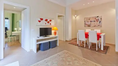 a kitchen and dining room with a table and a television at Circo Massimo Apartment 2 in Rome