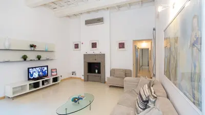 a living room with a couch and a tv at Rental in Rome Purificazione apartament in Rome