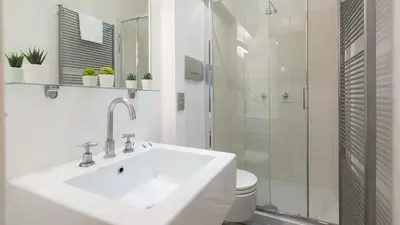 a white bathroom with a sink and a shower at Rental in Rome Purificazione apartament in Rome