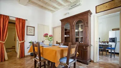 a dining room with a table and chairs at Rental in Rome Trevi Fouintain View Apartment in Rome