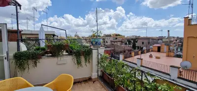 a balcony with chairs and a view of a city at Raffaello Terrace - near Piazza Navona in Rome