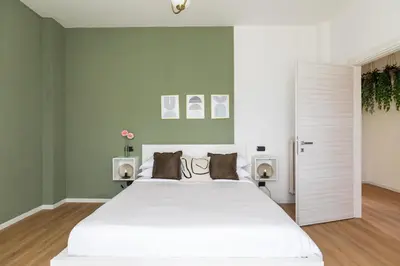 a bedroom with a large white bed with two speakers at [Ampio appartamento vicino al Vaticano] in Rome