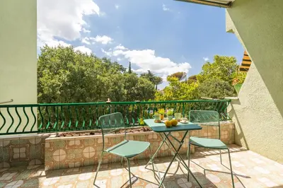 a patio with a table and chairs on a balcony at [Ampio appartamento vicino al Vaticano] in Rome