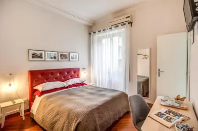 a bedroom with a bed and a table and a window at Circus Maximus B&B in Rome