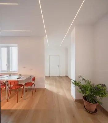a dining room with a table and chairs in a white room at Gianicolense 22 in Rome