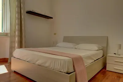 a bedroom with a large bed with a dresser at Colosseo Apt Mecenate 77 - Home and More in Rome