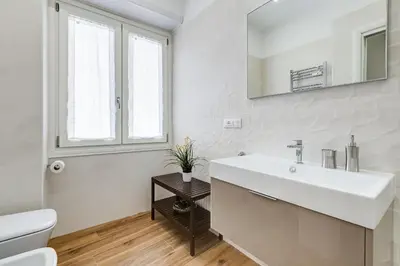 a white bathroom with a sink and a toilet at San Pietro Vatican Apartments in Rome