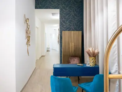 a dining room with two tables and chairs and a mirror at Alto Apartment in Rome