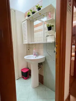 a bathroom with a white sink and a mirror at h135 in Rome