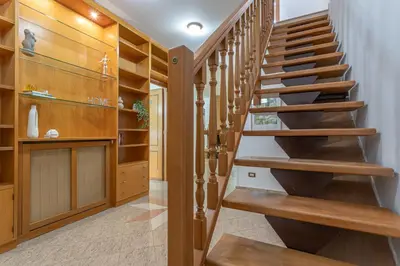 a winding staircase in a home with wood paneling at BBHOME Domus aquae inside of appia antica park in Rome