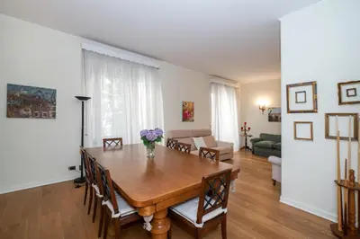 a dining room with a table and a living room at Appia96 Apartments in Rome