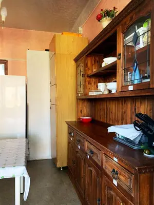 a kitchen with a wooden cabinet and a refrigerator at Villa Elena in Rome