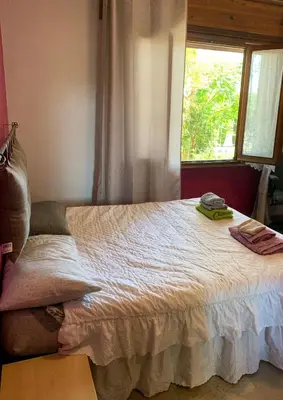 a bed in a bedroom with a window at Villa Elena in Rome