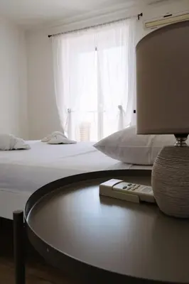 a bedroom with a bed and a table with a lamp at Appartamento San Giovanni Liliana in Rome