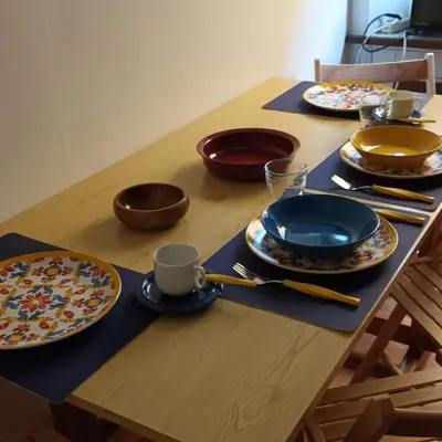 a wooden table with plates and cups on it at La Casa di Filippo in Rome