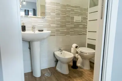 a bathroom with a sink and a toilet at Trastevere Guestrooms in Rome