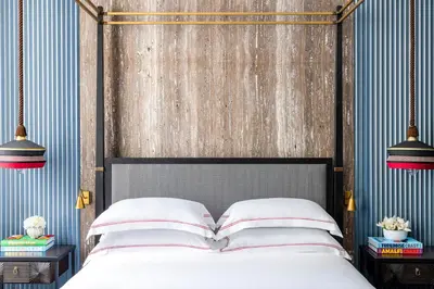 a bedroom with a bed with a wooden headboard at Palazzo Roma - The Leading Hotels of the World in Rome