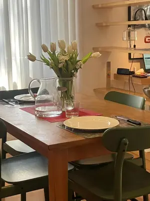 a wooden table with a vase of flowers on it at Monti Parioli House in Rome