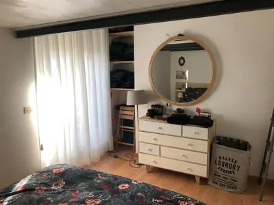 a bedroom with a bed and a dresser with a mirror at Monti Parioli House in Rome