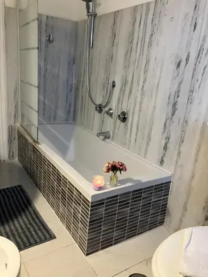 a bathroom with a bath tub with a shower at Monti Parioli House in Rome