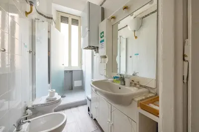 a white bathroom with a sink and a toilet at Vatican Stylish by Varental - Guardabassi Collection in Rome