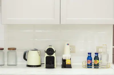 a kitchen counter with a coffee maker and other items at La Dolce Vita Boutique Guest House in Rome