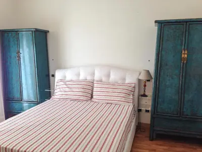 a bedroom with two green cabinets and a bed at Baccina Inn in Rome