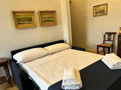 a bedroom with a bed with two towels on it at Manzoni Blue House by GHOR in Rome