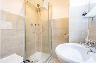 a bathroom with a shower and a sink and a toilet at Ethnos Relais Vaticano in Rome