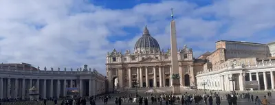 a large building with people walking in front of it at Vaticano Ferrari Apartment in Rome