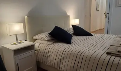 a bedroom with a bed with two pillows on it at Vaticano Ferrari Apartment in Rome