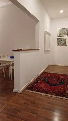 a white room with a rug and a white wall at Vaticano Ferrari Apartment in Rome