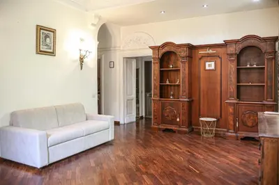 a living room with a couch and a wooden cabinet at Bpremium apartment in Rome