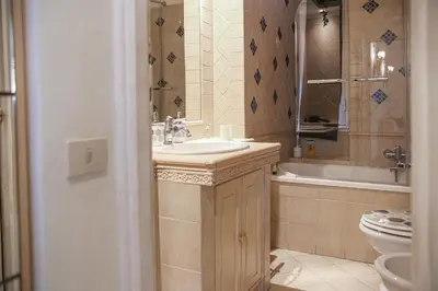 a bathroom with a sink and a tub and a toilet at Bpremium apartment in Rome