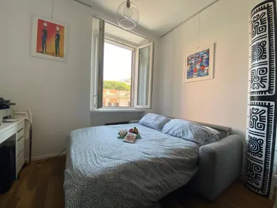 a bedroom with a bed and a window at Leopardi Sweet Home in Rome