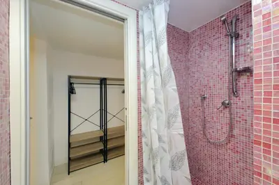 a bathroom with a walk in shower next to a glass door at Flatinrome Trastevere 2 - Jacuzzi in Trastevere in Rome