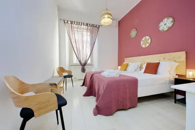 a bedroom with a bed and a table and chairs at Flatinrome Trastevere 2 - Jacuzzi in Trastevere in Rome