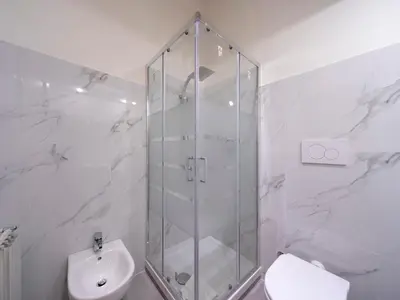 a white bathroom with a shower and a toilet at Spanish Steps, Suite Dominic, Strollingrome in Rome