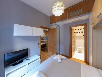 a room with a bed and a tv and a bathroom at Spanish Steps, Suite Dominic, Strollingrome in Rome