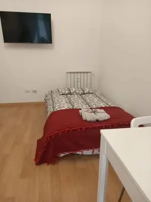 a bedroom with a bed with a red blanket at CasaLara Garden in Rome